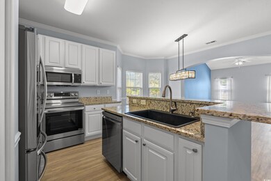Kitchen with white cabinets, a sink, ceiling fan, 