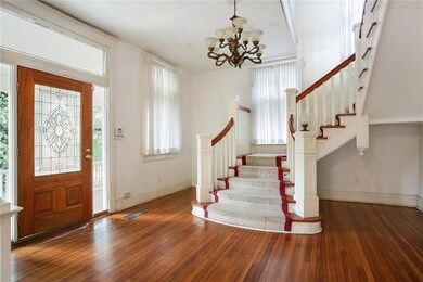 Gracious Foyer with an elegant staircase.