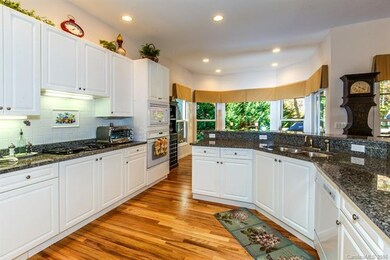 Kitchen has under-counter lighting, tile back spla