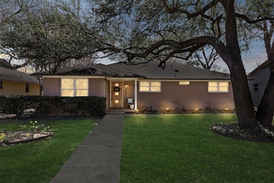 Single story home featuring a front lawn and brick