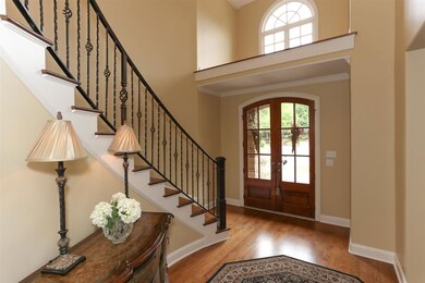 Grand 2-Story Entry with elegant wrought iron chan