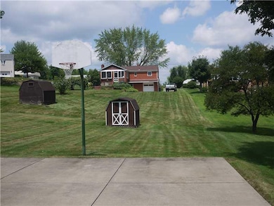 Exterior Front. Almost flat back yard with Storage