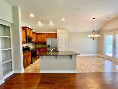 Kitchen featuring light wood-type flooring, applia