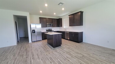 Kitchen with stainless steel appliances, light wo
