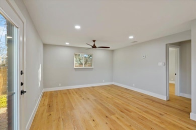 Spare room featuring baseboards, a ceiling fan, r