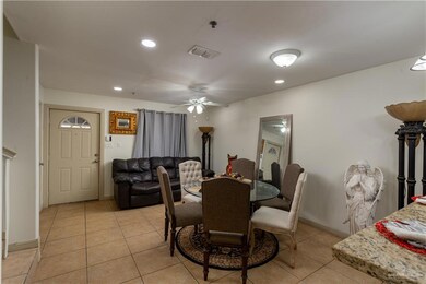 Dining space featuring light tile flooring and ceiling fan