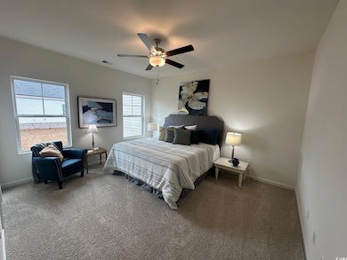 Carpeted bedroom with ceiling fan