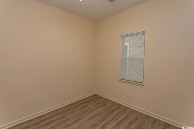 Spare room featuring baseboards, a textured ceilin