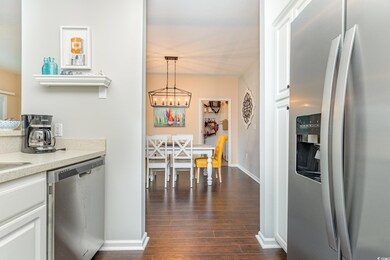 Kitchen featuring decorative light fixtures, stain