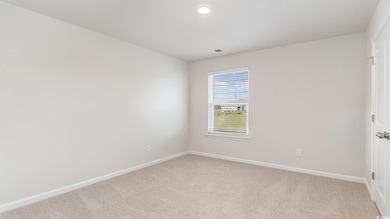 Spare room featuring carpet floors