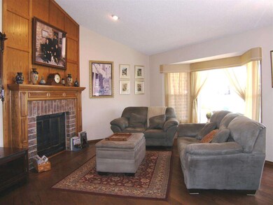 Woodburning fireplace and hardwood floors add to t