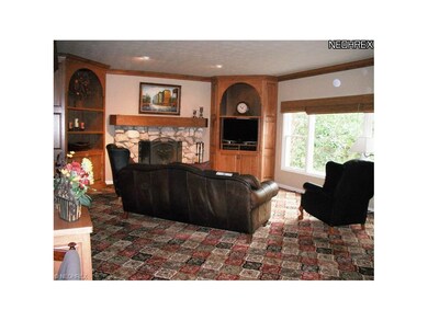 Great room with stone gas-log fireplace flanked by