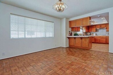 Formal dining room with wood paneled flooring conveniently next to the kitchen. Imagine the dinner parties!