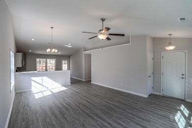 Unfurnished living room with lofted ceiling, dark 