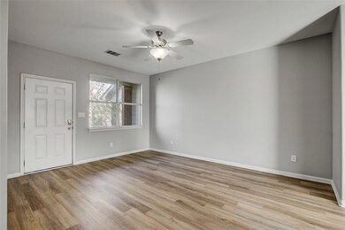 Empty room featuring a ceiling fan and wood finis