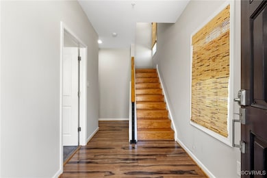 Stairs featuring baseboards, wood finished floors,