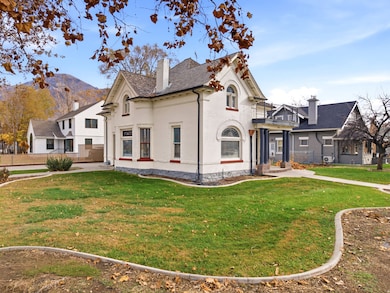View of front of house with brick siding, a front yard, and a chimney