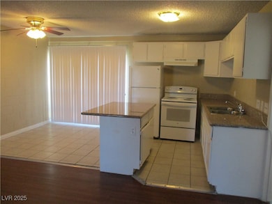 Kitchen featuring white appliances, under cabinet