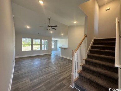 Staircase with lofted ceiling, baseboards, wood finished floors, and recessed lighting