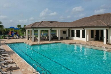 View of pool with a playground and a patio
