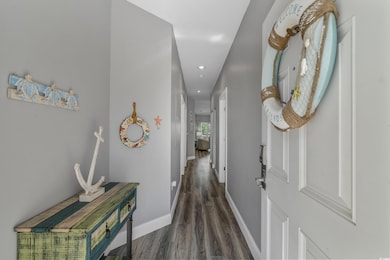 Corridor featuring baseboards, recessed lighting, and wood finished floors