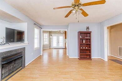 Foyer entrance to right and kitchen in rear