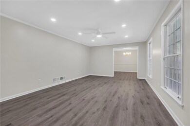 Unfurnished room with ornamental molding, a ceiling fan, recessed lighting, dark wood-style floors, and baseboards