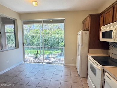 Kitchen with white appliances, healthy amount of n