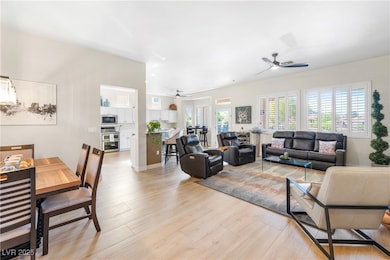 Living area featuring a ceiling fan and high ceili