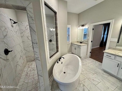 Full bath with a soaking tub, two vanities, marble