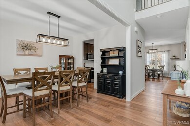 Dining room with light wood-type flooring, baseboa