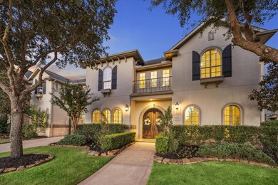 Stunning arched wood double doors and balcony greet you as you walk up to this impeccable home!