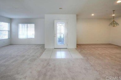 View of front door with living room and dining roo