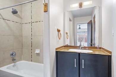 Bathroom featuring vanity and shower / tub combo with curtain