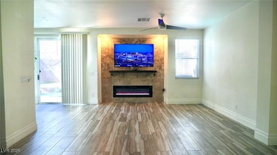 Unfurnished living room featuring wood finished fl