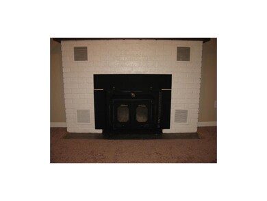 Fantastic brick fireplace with woodstove insert in