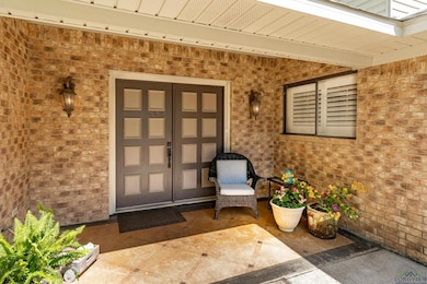 Entrance to property featuring brick siding
