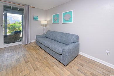 Living area featuring light wood finished floors and baseboards