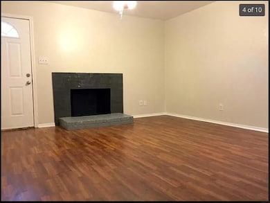 Unfurnished living room featuring dark wood-style