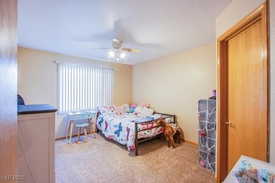 Bedroom featuring carpet flooring and a ceiling fa