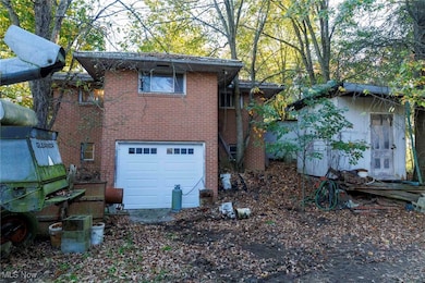 View of home's exterior featuring brick siding and an attached garage