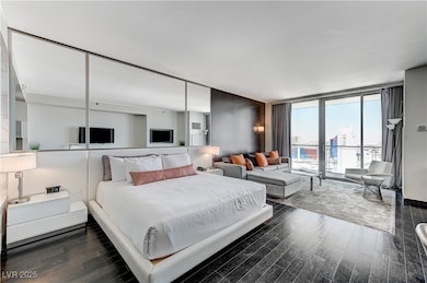 Bedroom featuring dark wood-type flooring and expa