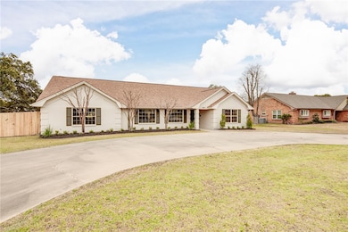 Ranch-style home with curved driveway