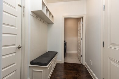 Mudroom featuring dark wood finished floors and ba