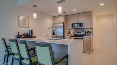 Kitchen with light tile patterned flooring, backsp