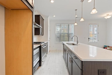 Kitchen with a sink, stainless steel gas range, a 