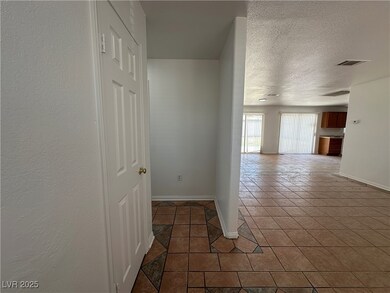 Hallway with tile patterned flooring, baseboards,