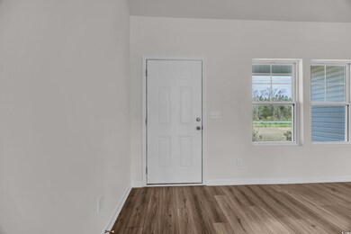 Foyer entrance featuring baseboards and dark wood-