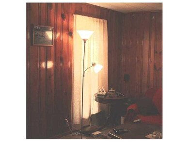 Living Room. Knotty pine wood walls. 2 windows and