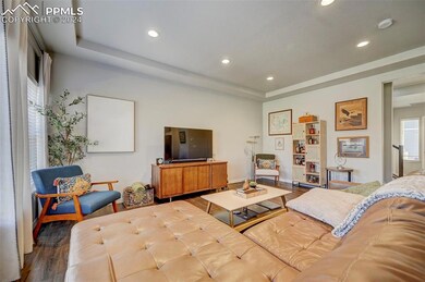 Living room with hardwood / wood-style flooring an